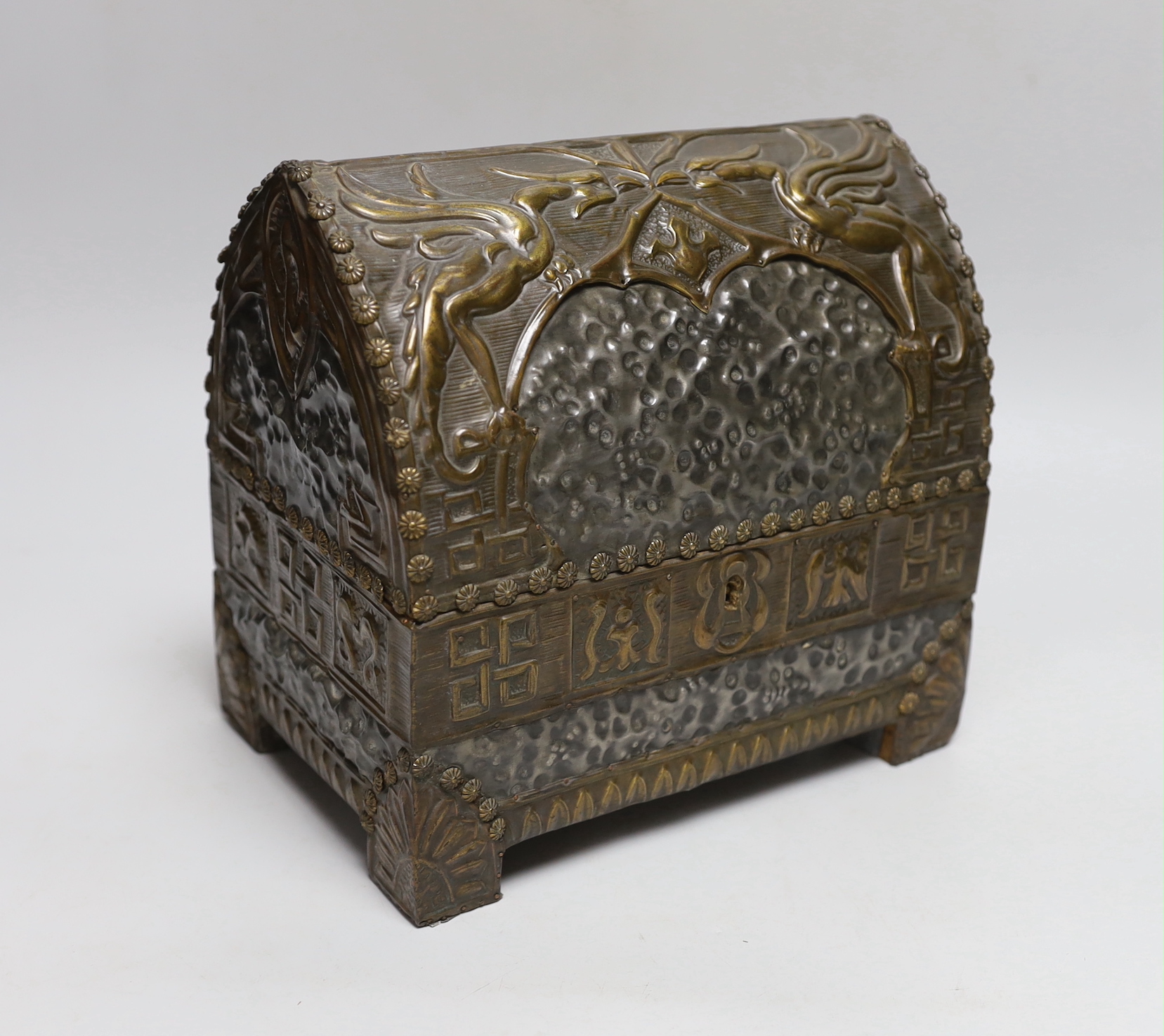 An early 20th century hammered pewter and brass neo-gothic casket, with poker work and velvet interior, 22cm high